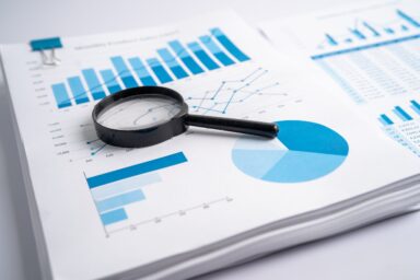 Magnifying glass on charts graphs paper. Financial development, Banking Account, Statistics, Investment Analytic research data economy, Stock exchange trading, Business office company meeting concept.