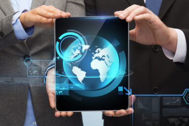business, technology and internet concept - businessman and businesswoman with globe on tablet pc computer screen